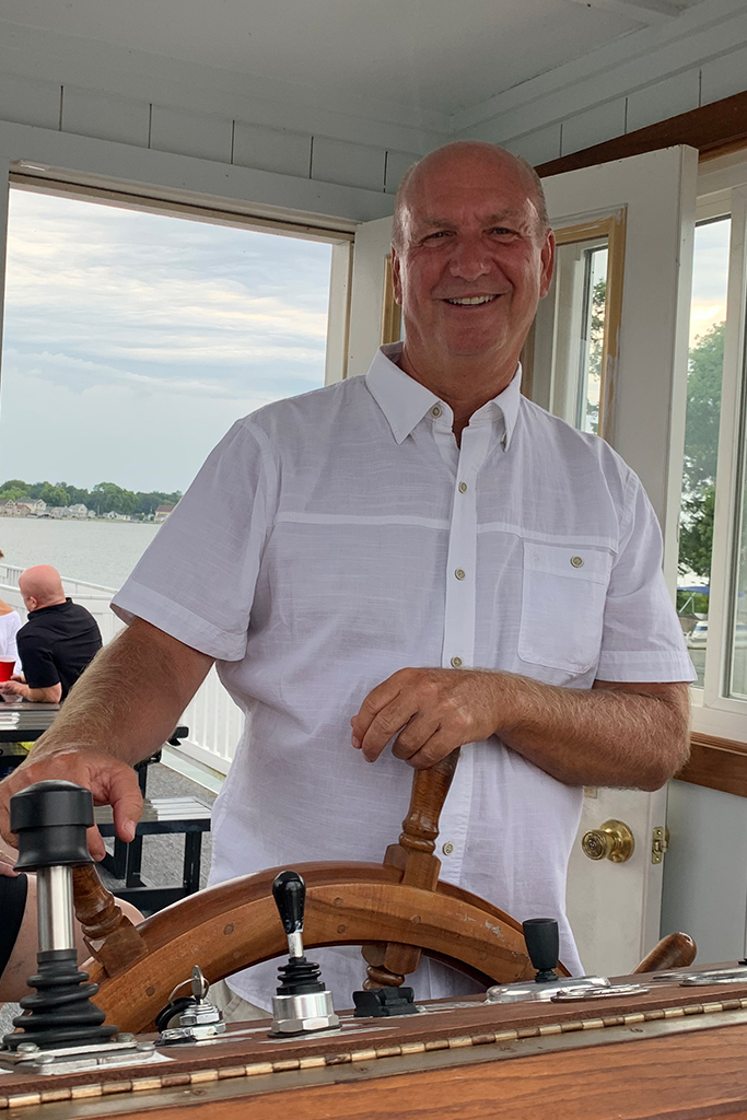 captain at boat steering wheel